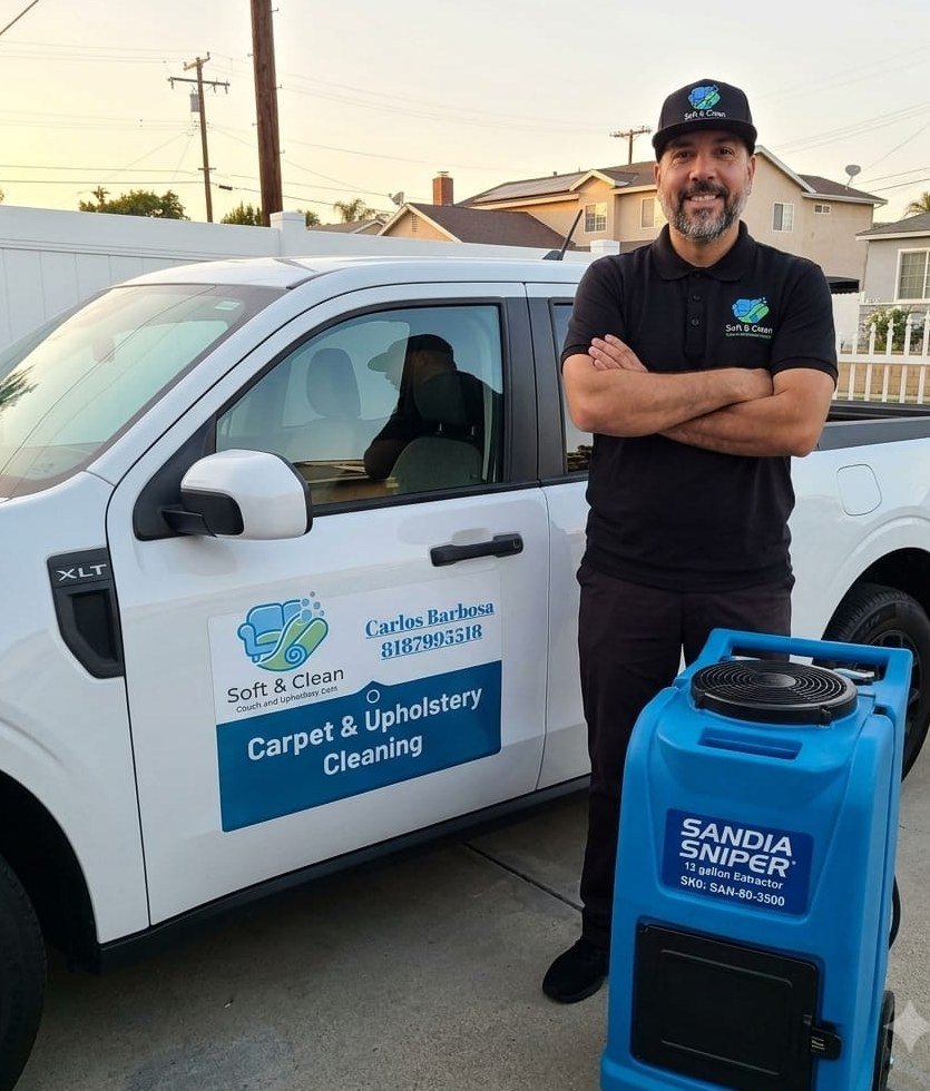 Carlos Barbosa, owner of Soft & Clean Carpet and Upholstery Care, beside his branded truck and extraction machine