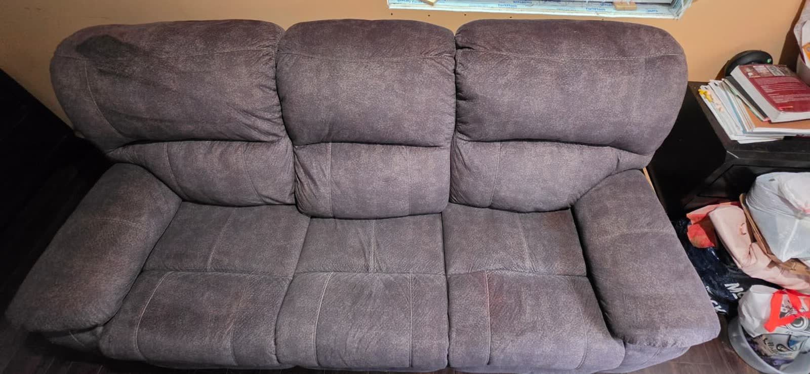 Brown microfiber reclining sofa with faded, worn-looking fabric before cleaning