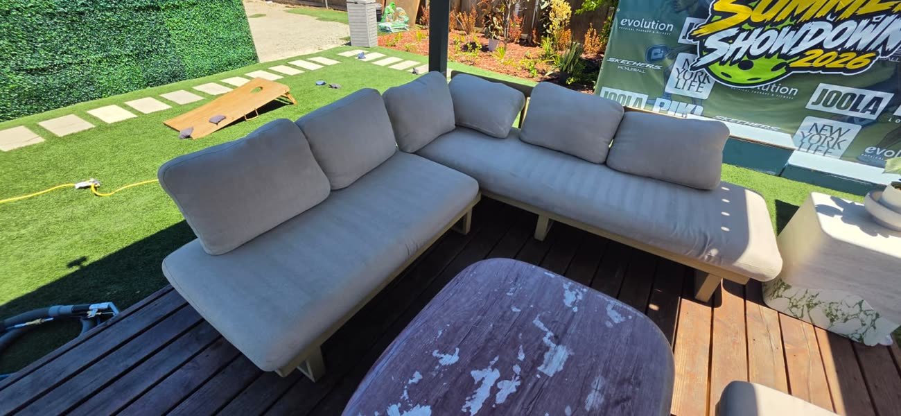 Outdoor patio sectional sofa with light gray cushions, freshly cleaned